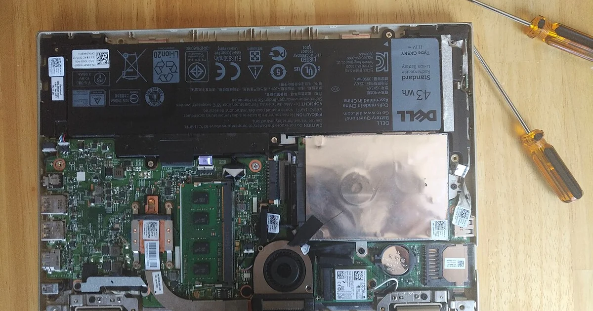A Dell Inspiron 2-in-1 tablet laptop with the back cover removed. At the time of taking the photo the laptop was non-functional and retired from use.
